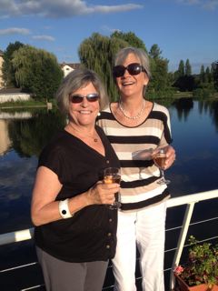 Gail and Nancy sipping wine on Luciole's deck